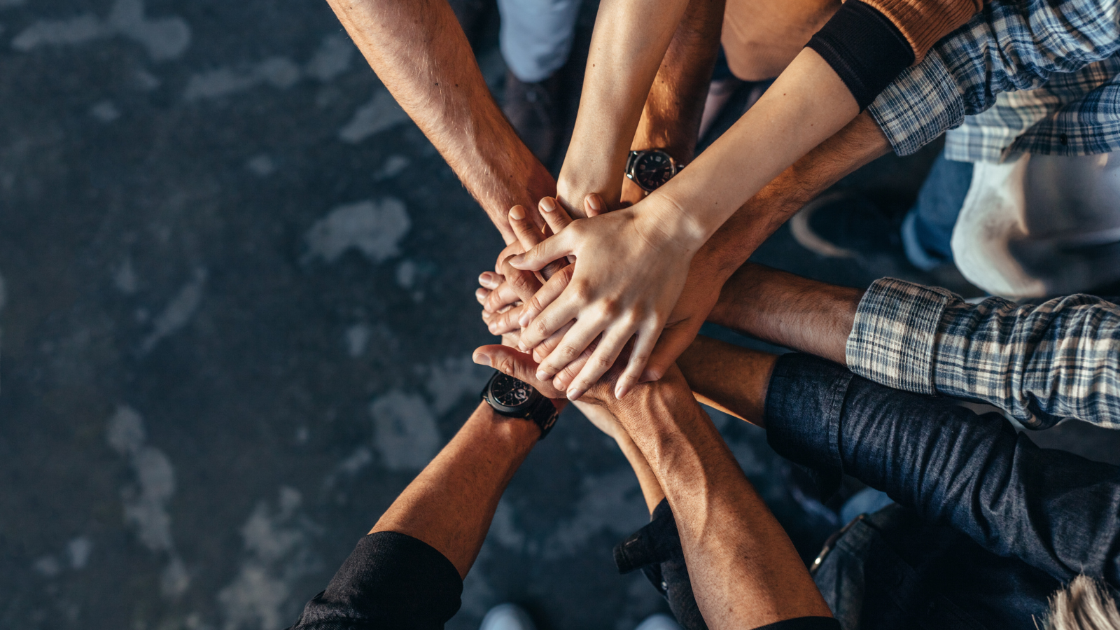 Team collaboration - hands stacked together